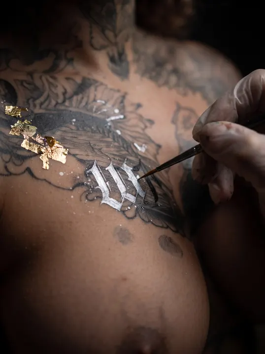 AI image: Gold leaf being pressed onto painted lettering
