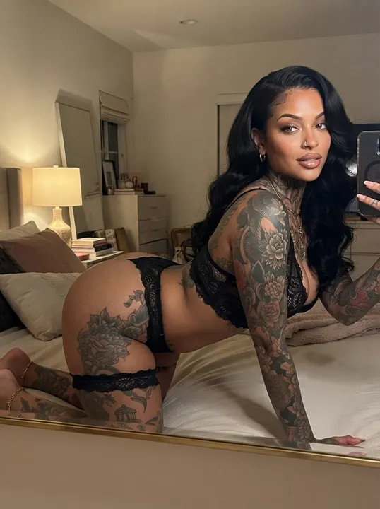 AI image: A selfie on a hotel bed in black lingerie