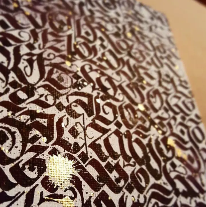 Close-up of dense brown and black blackletter covering a canvas