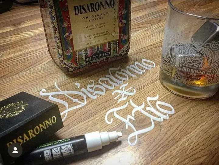 Disaronno lettered in white beside the bottle and a glass
