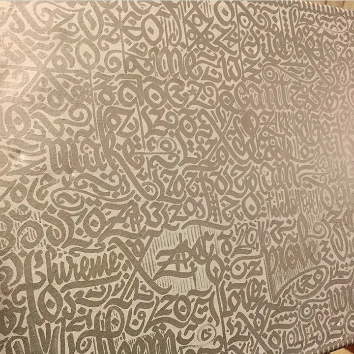 Dense interlocking letterforms in grey and silver covering the page