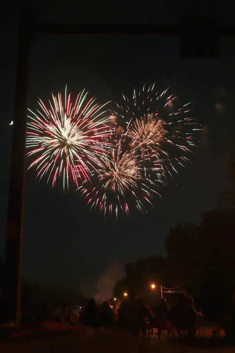 Fireworks over a dark street