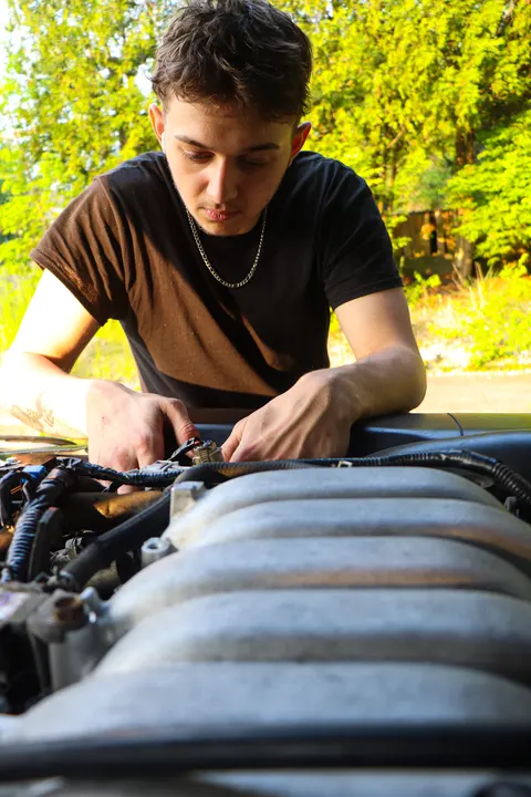 A young man working on an engine