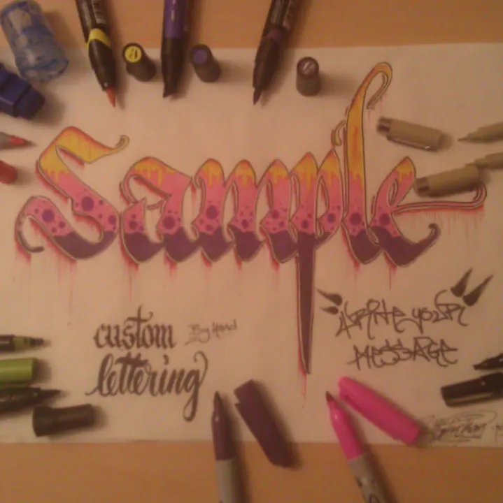 Sample in pink and red blackletter with the words custom lettering and your message, surrounded by markers