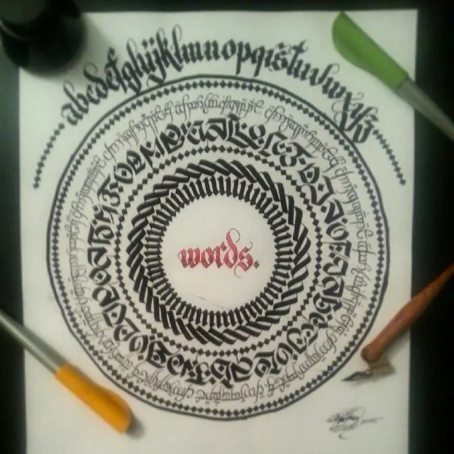 A word mandala in black ink around the word words, with the pens beside it